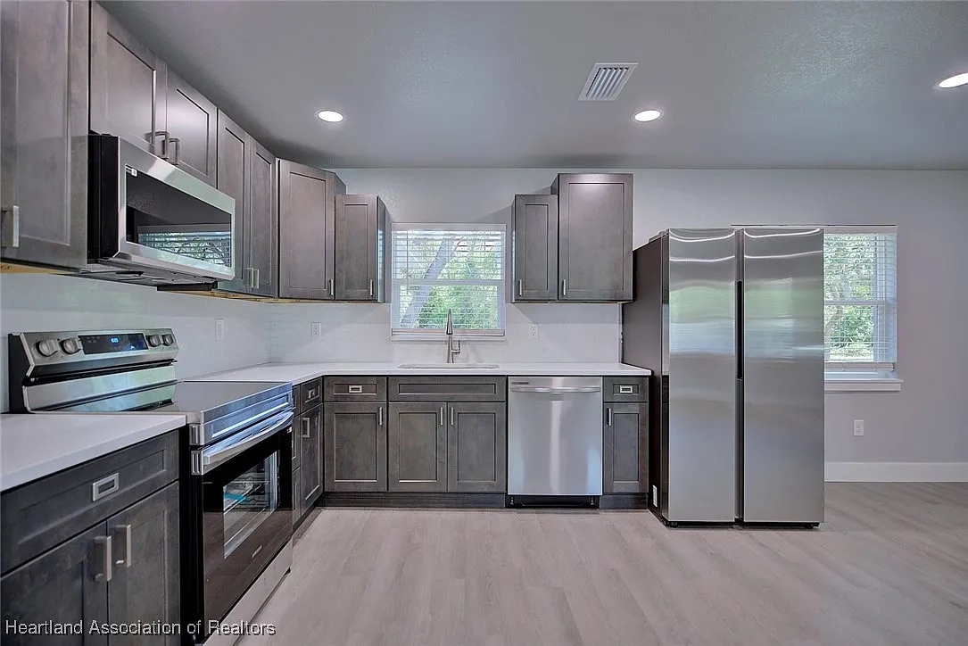 Gray Shaker cabinet installation in a compact kitchen